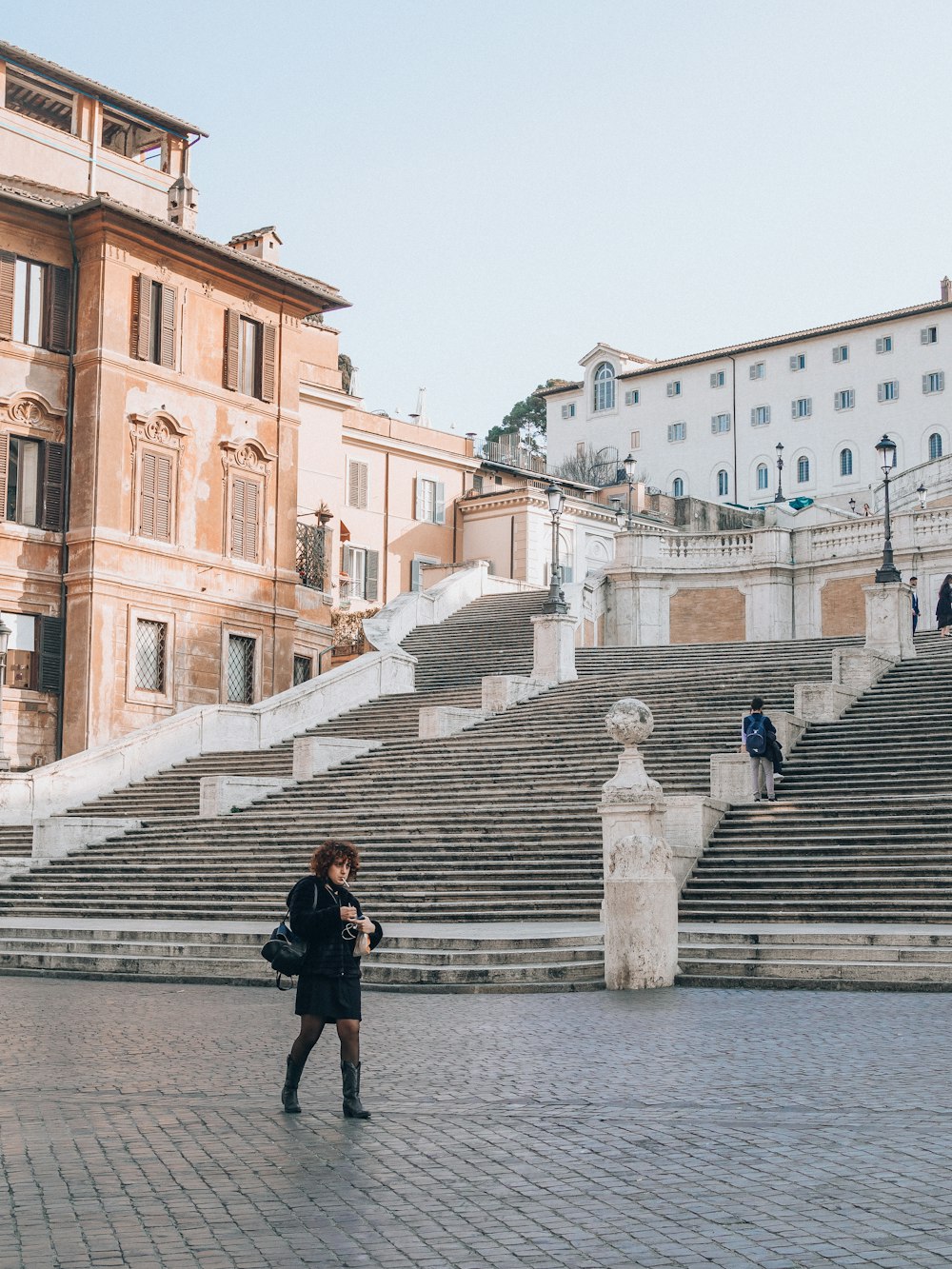 a woman standing in front of some steps