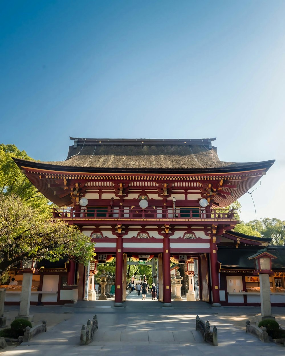 a tall red and white building sitting under a blue sky