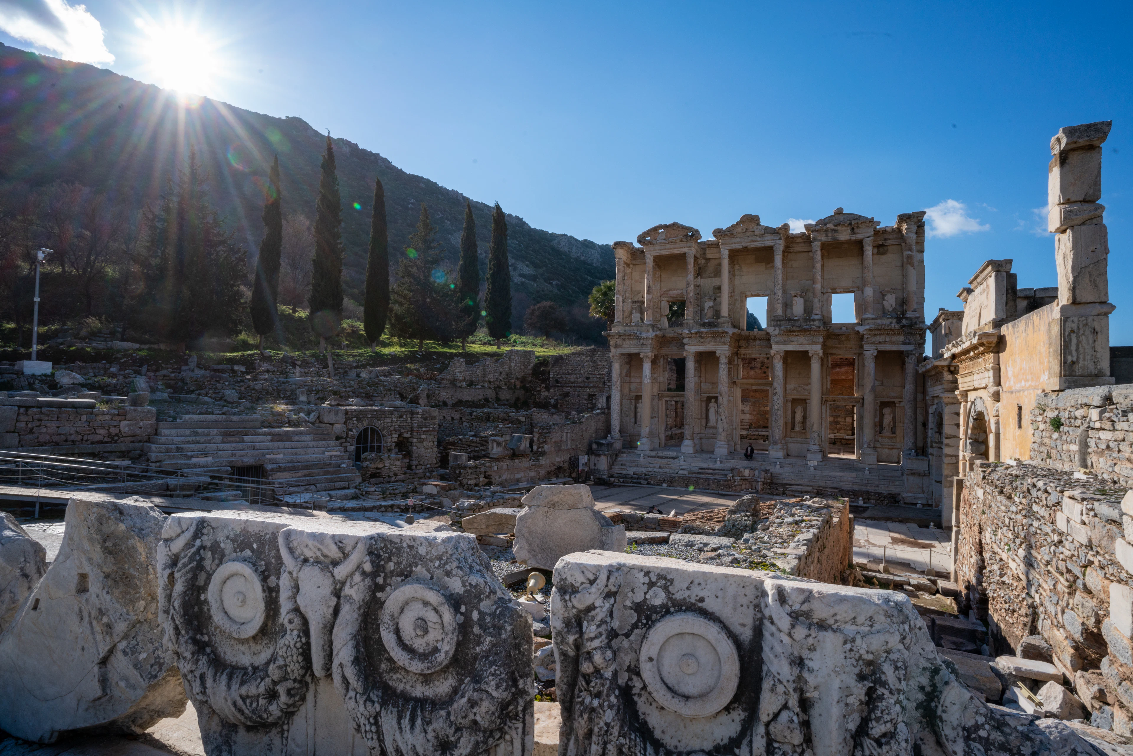 The facade of the Library of Celsus at Ephesus, with carved marble fragments in the foreground