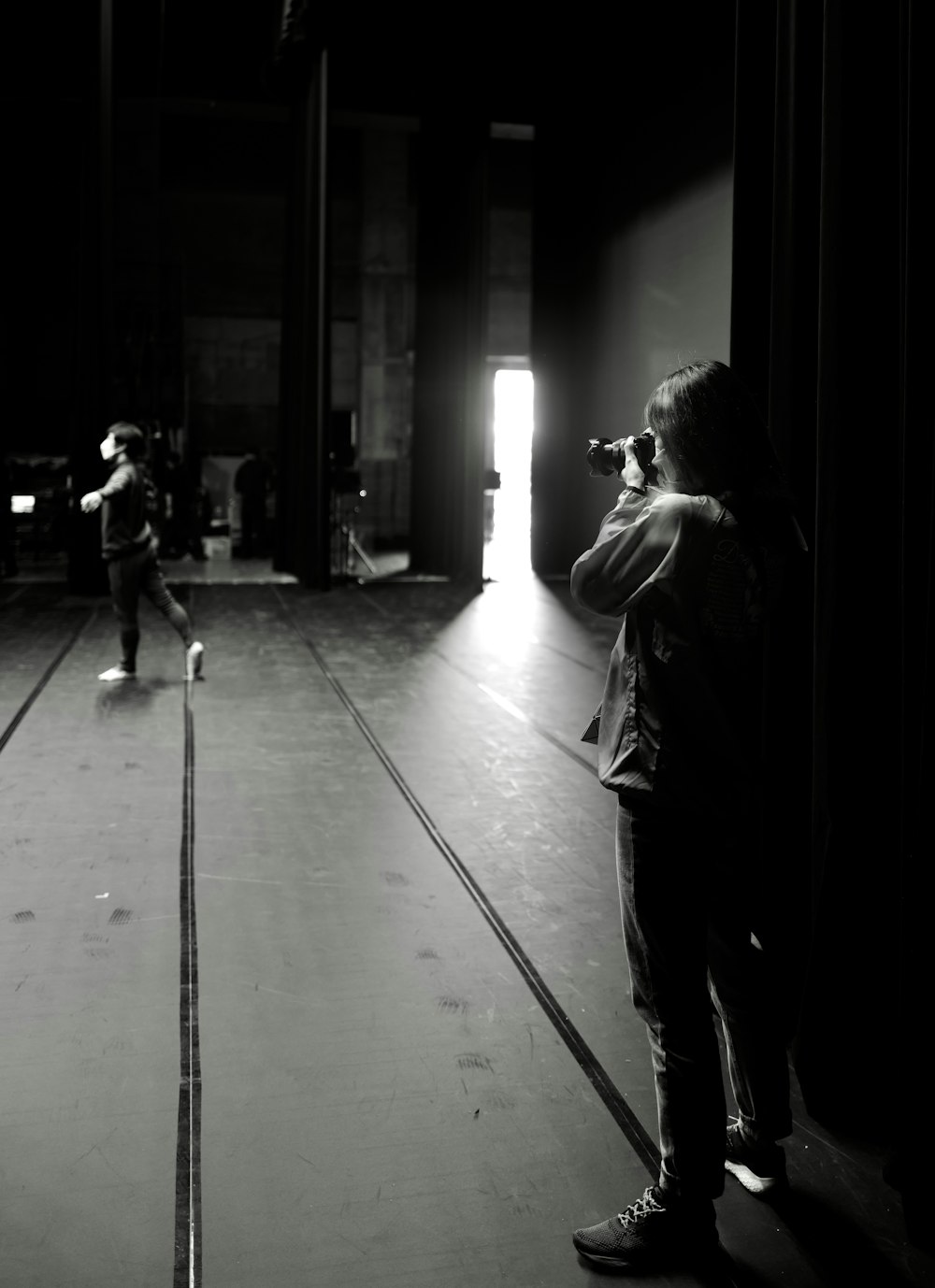 a person taking a picture of another person in a dark room