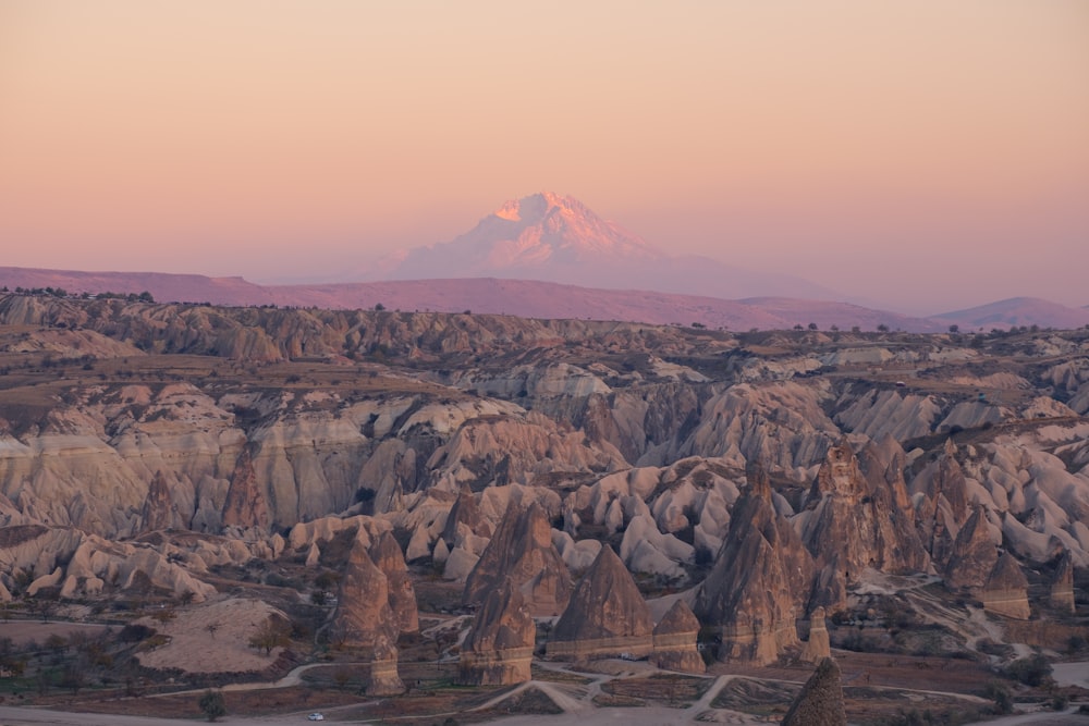 a view of a mountain range from the top of a hill