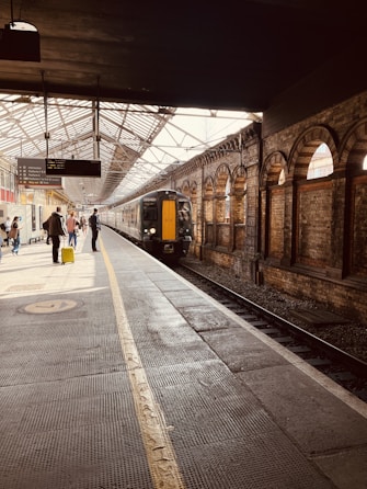 a train pulling into a train station next to a platform