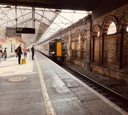 a train pulling into a train station next to a platform