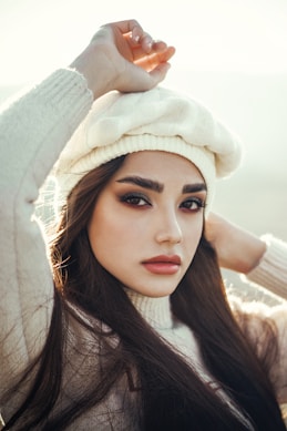 a woman with long hair wearing a white hat