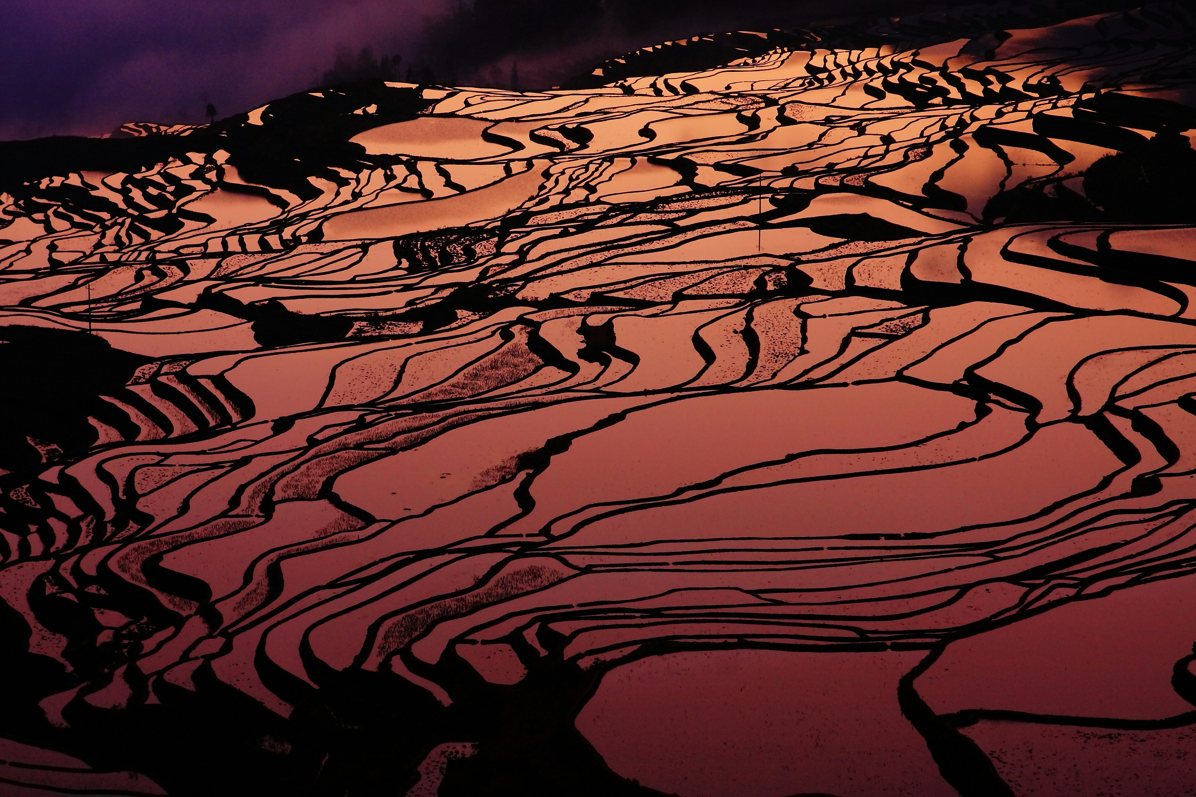 a view of a snow covered mountain at sunset