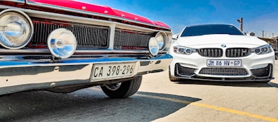 Side view of two electric cars parked side by side for comparison.