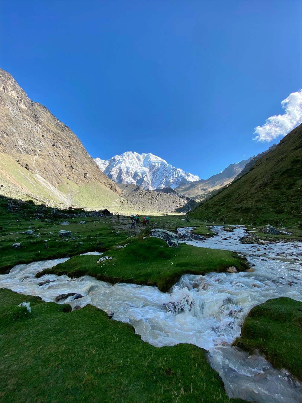 a river running through a lush green valley