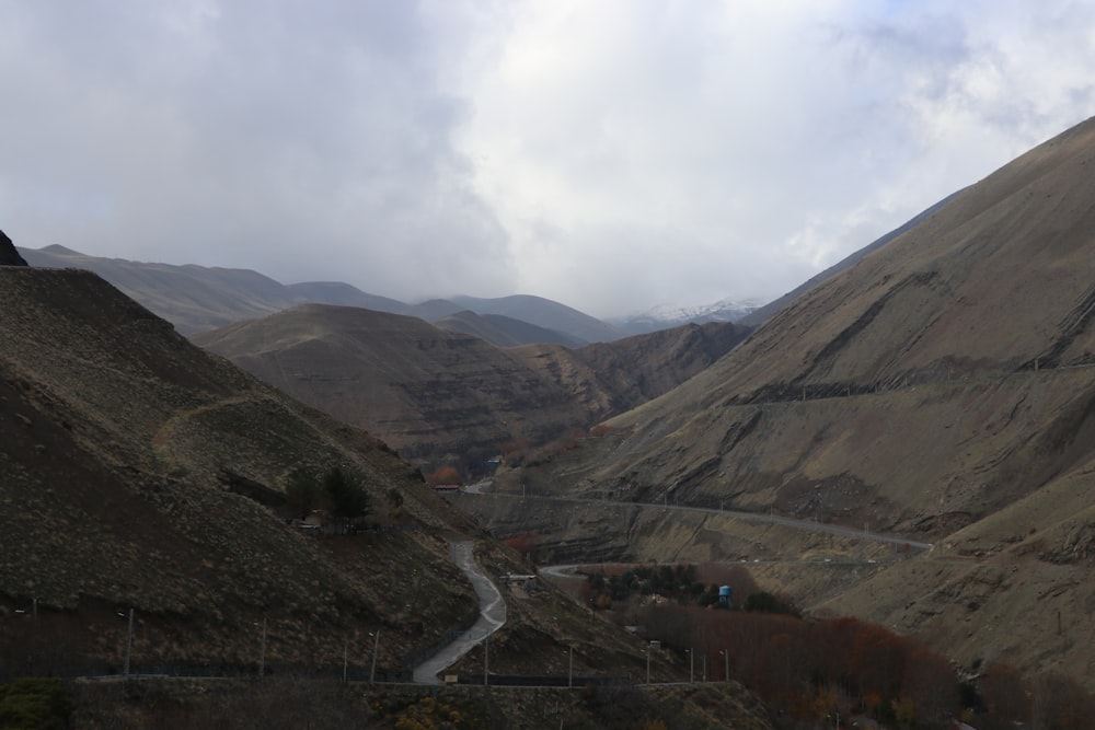 a scenic view of a valley with a winding road