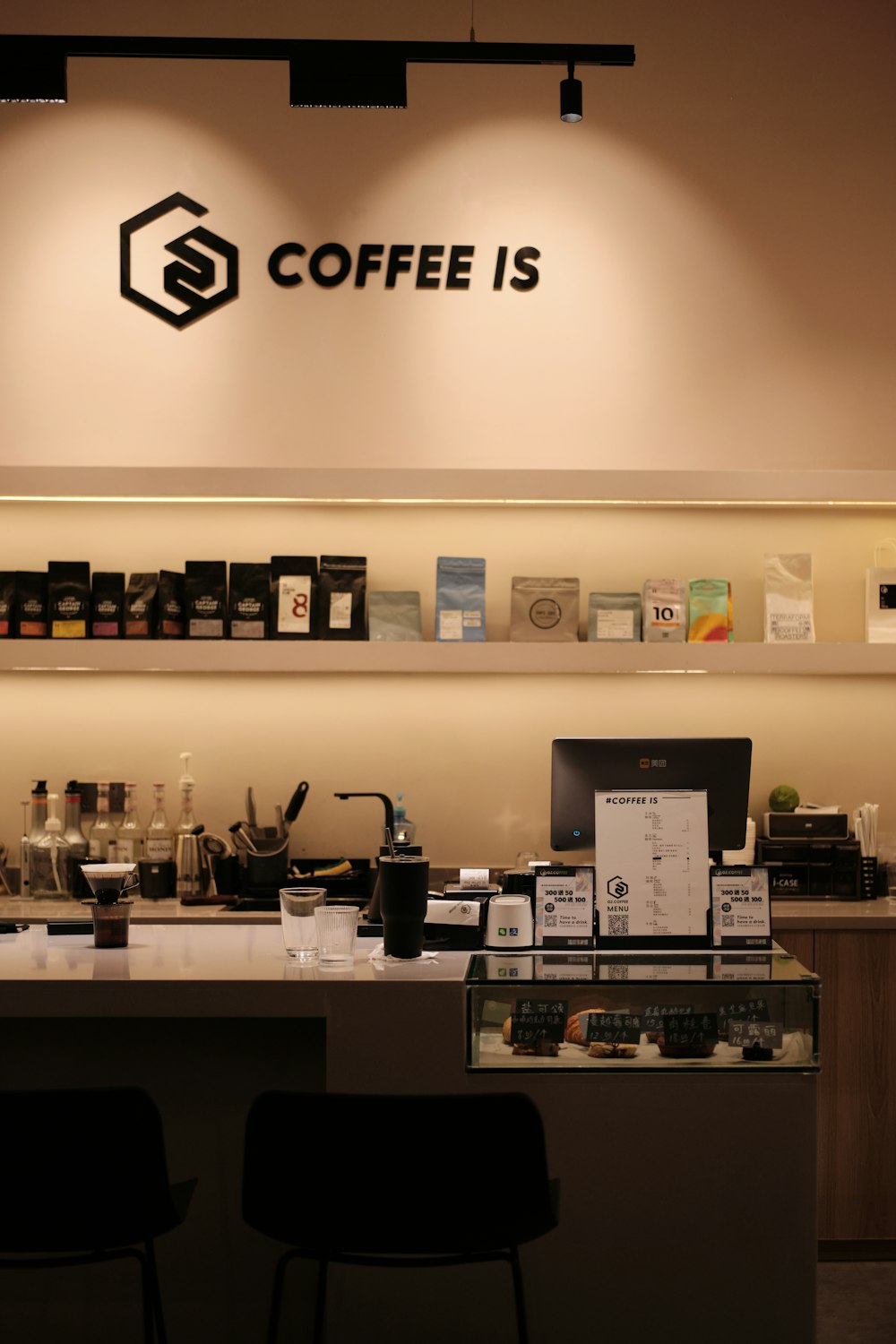 a coffee shop with a sign above the counter