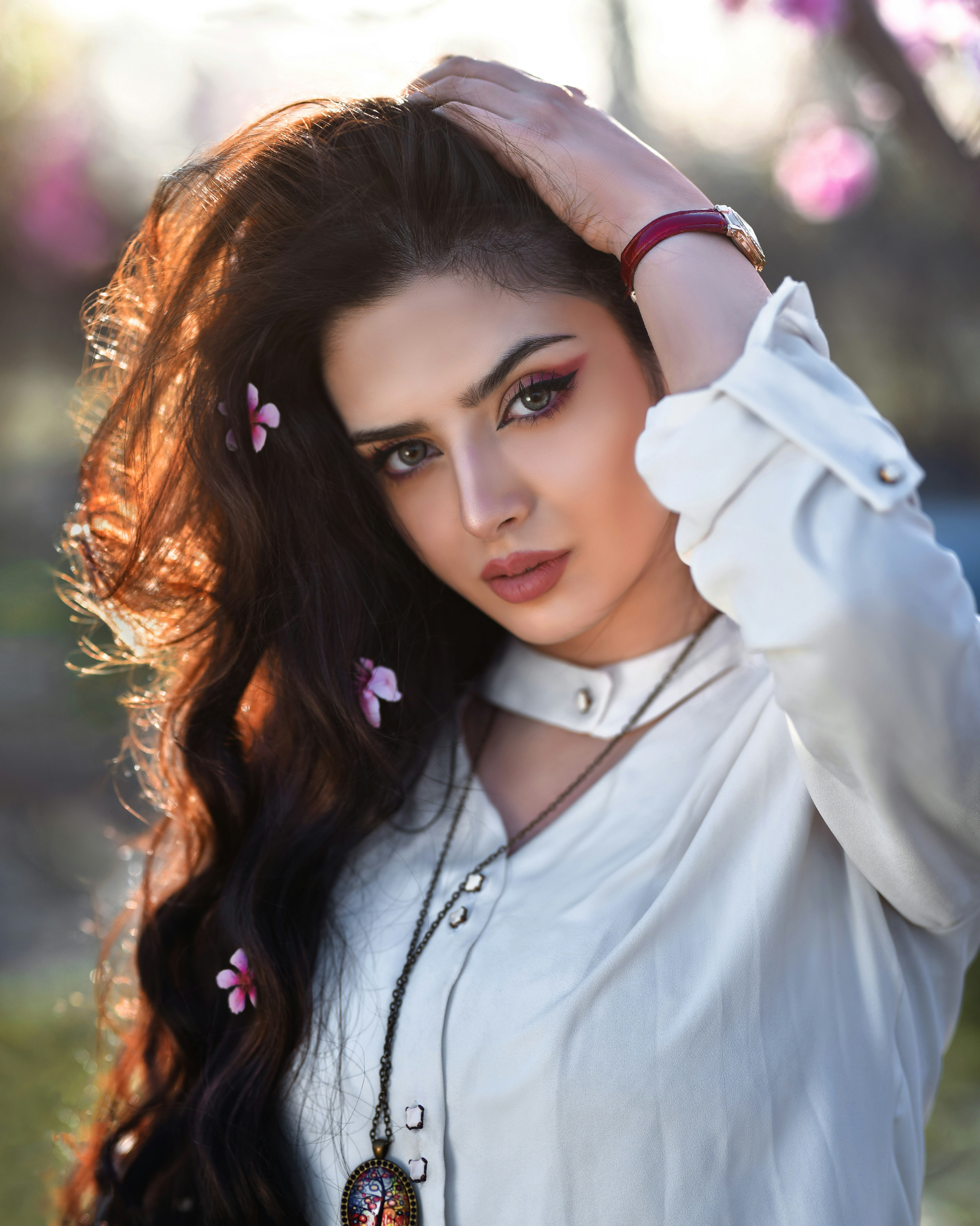 a woman with long hair wearing a white shirt