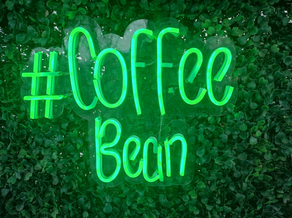 a green neon sign that says coffee bean