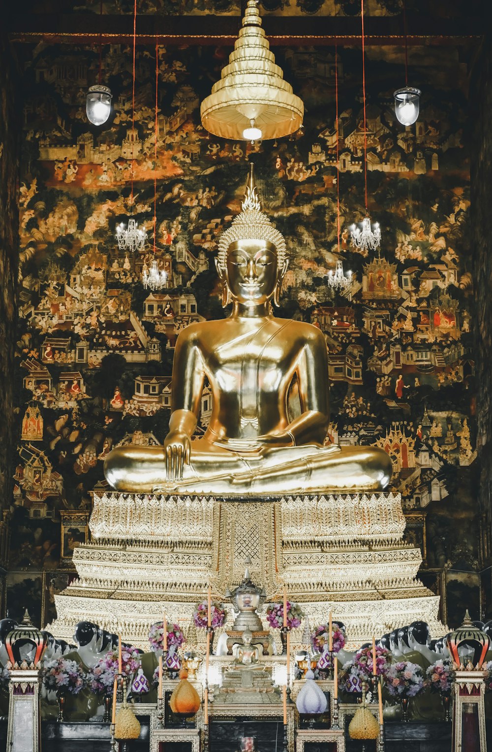 a large golden buddha statue sitting in a room