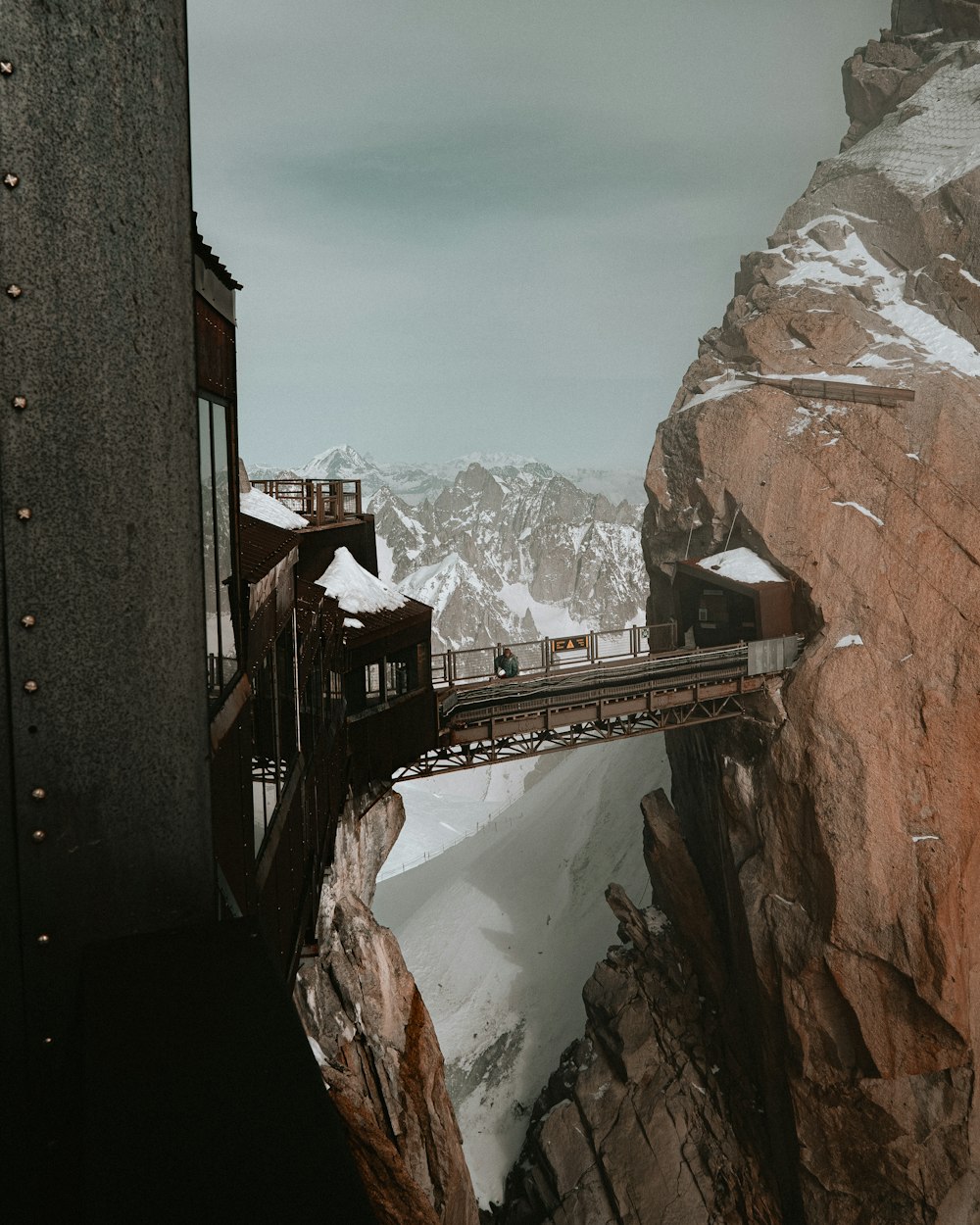 a train traveling over a bridge on top of a mountain
