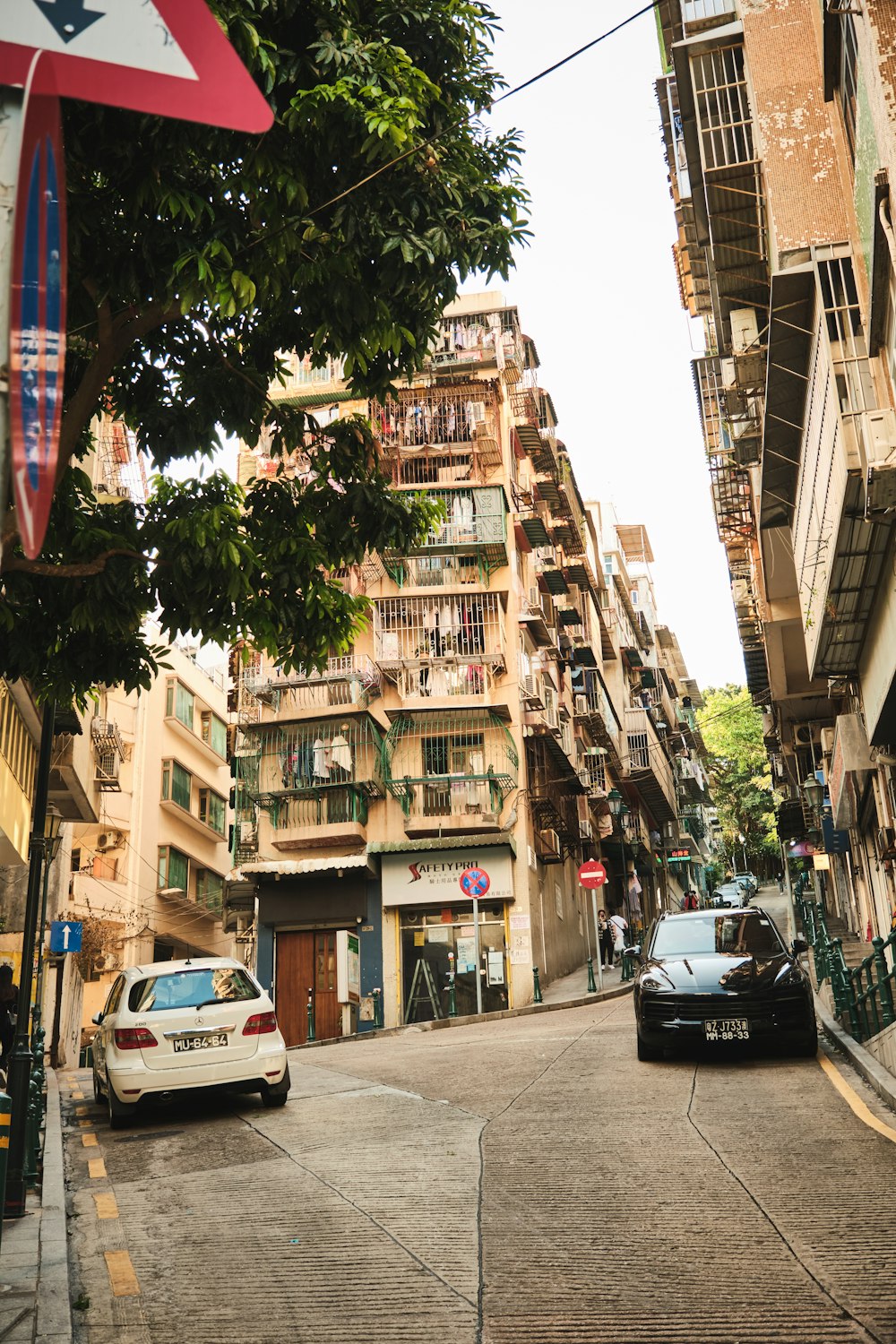 a car driving down a street next to tall buildings