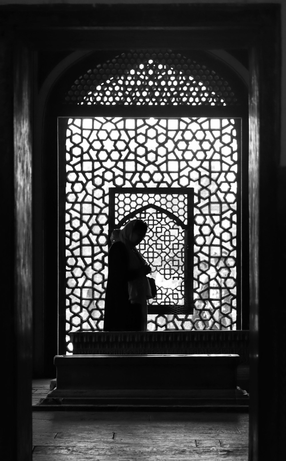 a person standing in front of a window in a building