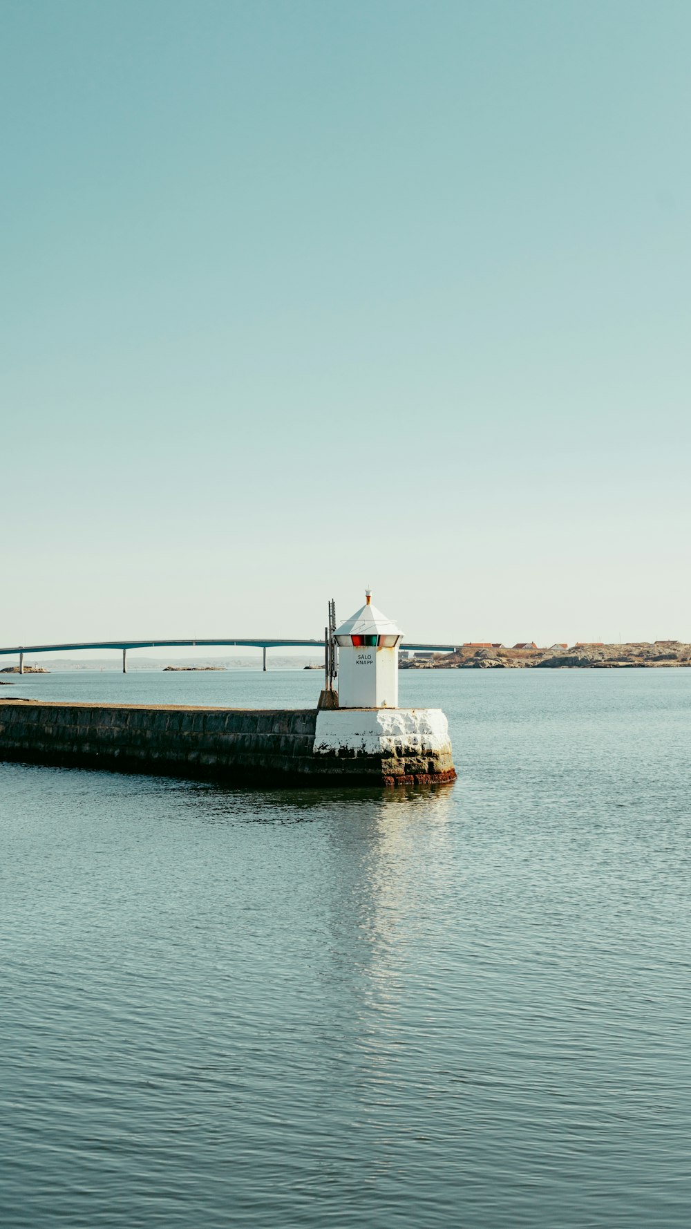 a pier with a bridge in the background