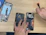 A technician carefully repairing a Samsung smartphone with tools on a workbench.