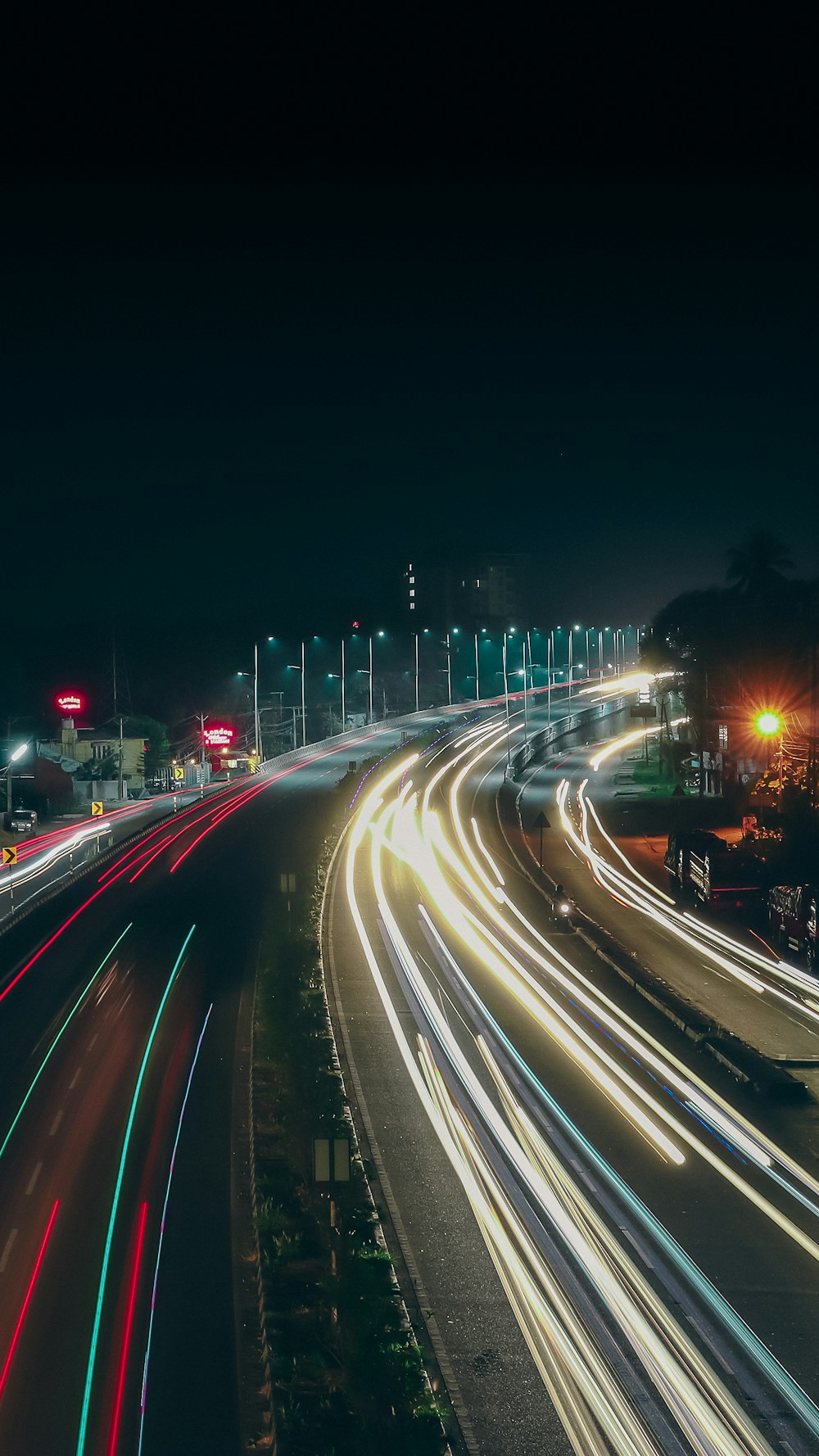 a long exposure photo of a highway at night