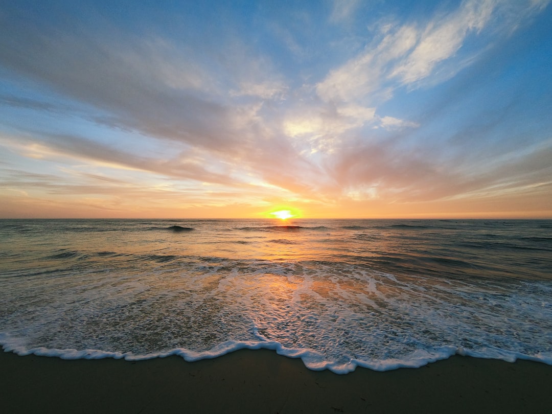 the sun is setting over the ocean on the beach, Last light at Windansea Beach in San Diego, CA