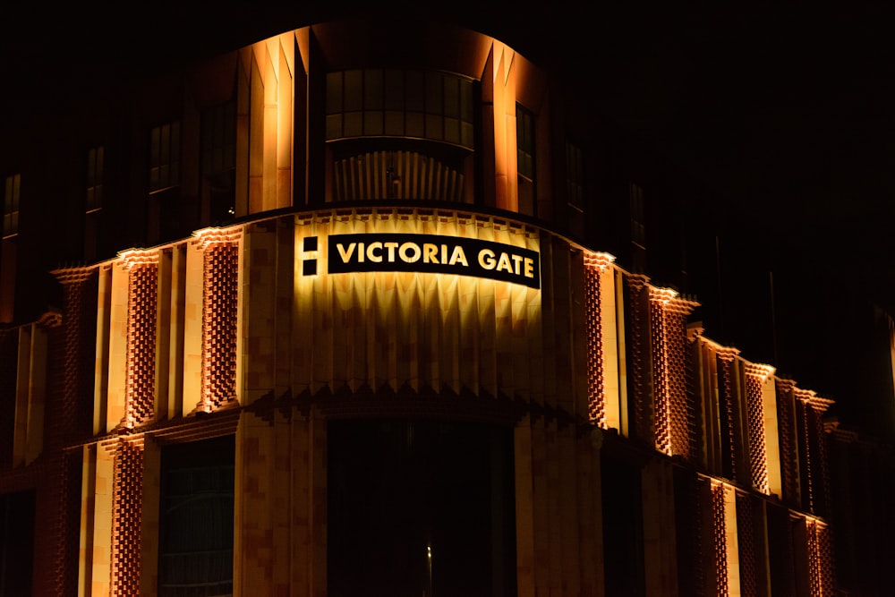 a very tall building with a lit up sign on it's side