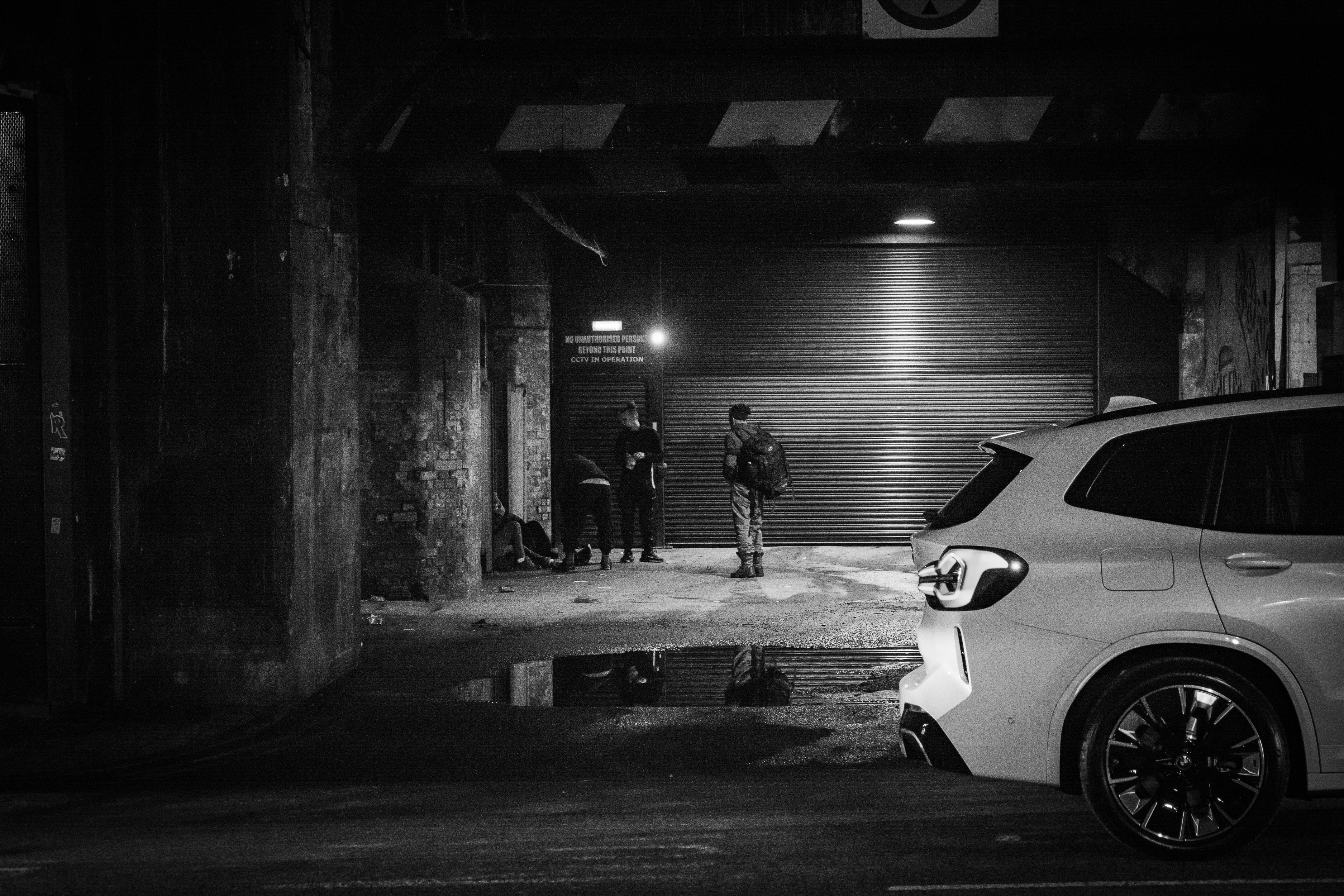 a car parked in front of a garage door