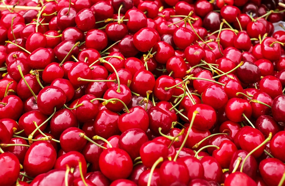 a pile of cherries sitting on top of a table