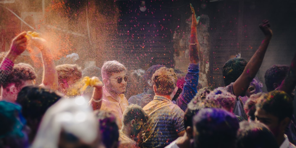 a group of people covered in colored powder