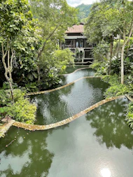 A serene residential complex surrounded by lush greenery and spiritual motifs.