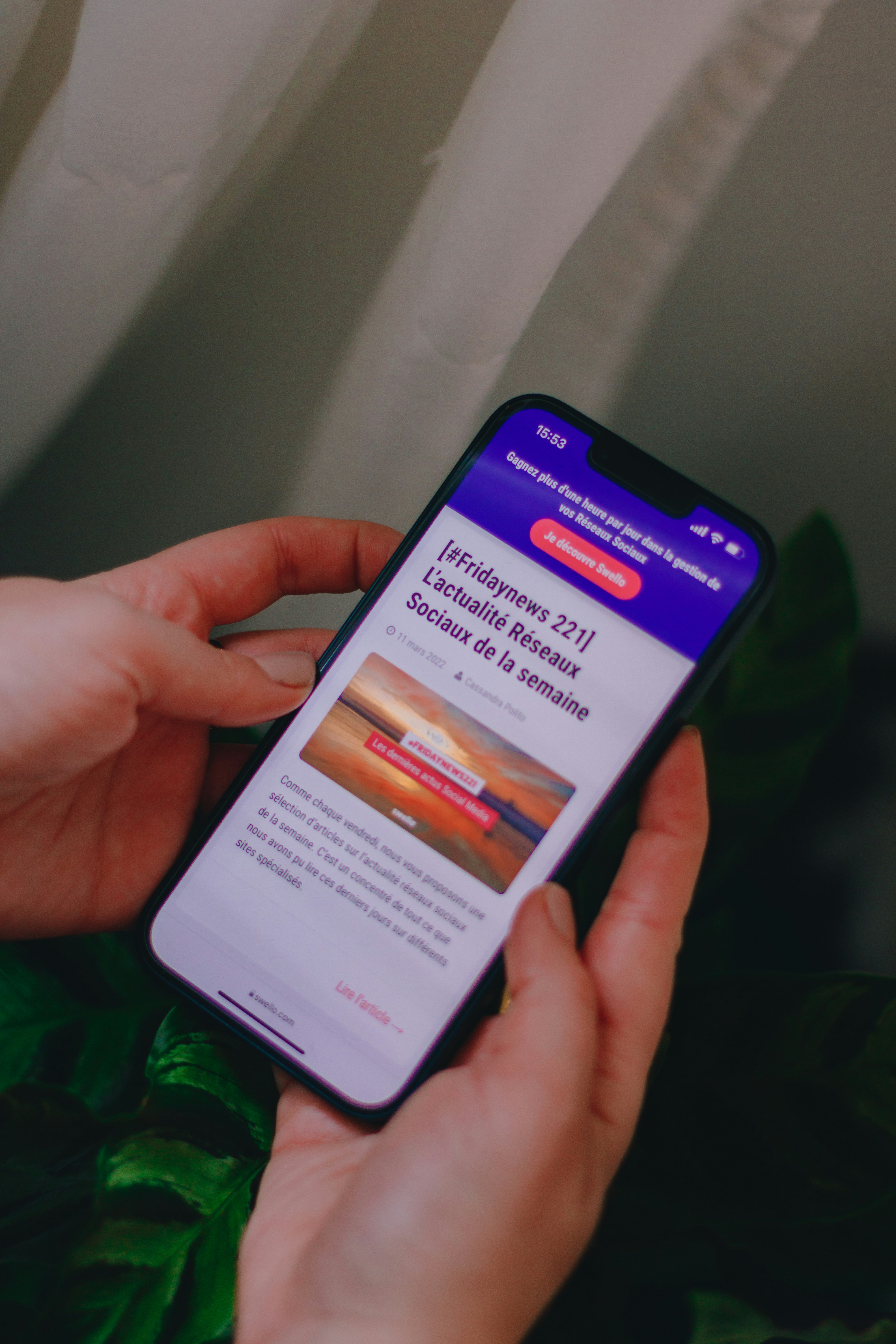 a person holding a cell phone in their hand