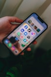 a person holding a cell phone in their hand
