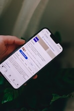 a person holding a cell phone in their hand