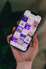 a person holding a cell phone in their hand