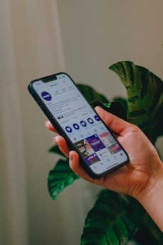 a person holding a cell phone in their hand