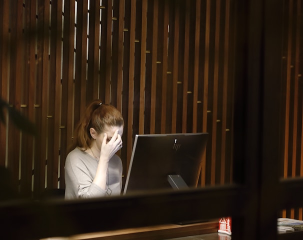 a woman sitting in front of a laptop computer