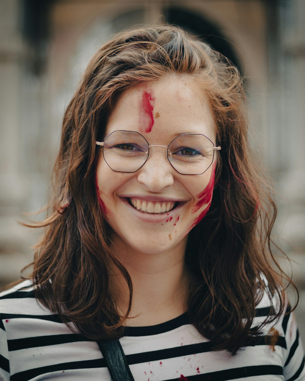 a woman with blood on her face and glasses