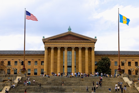 a group of people walking up and down steps in front of a building