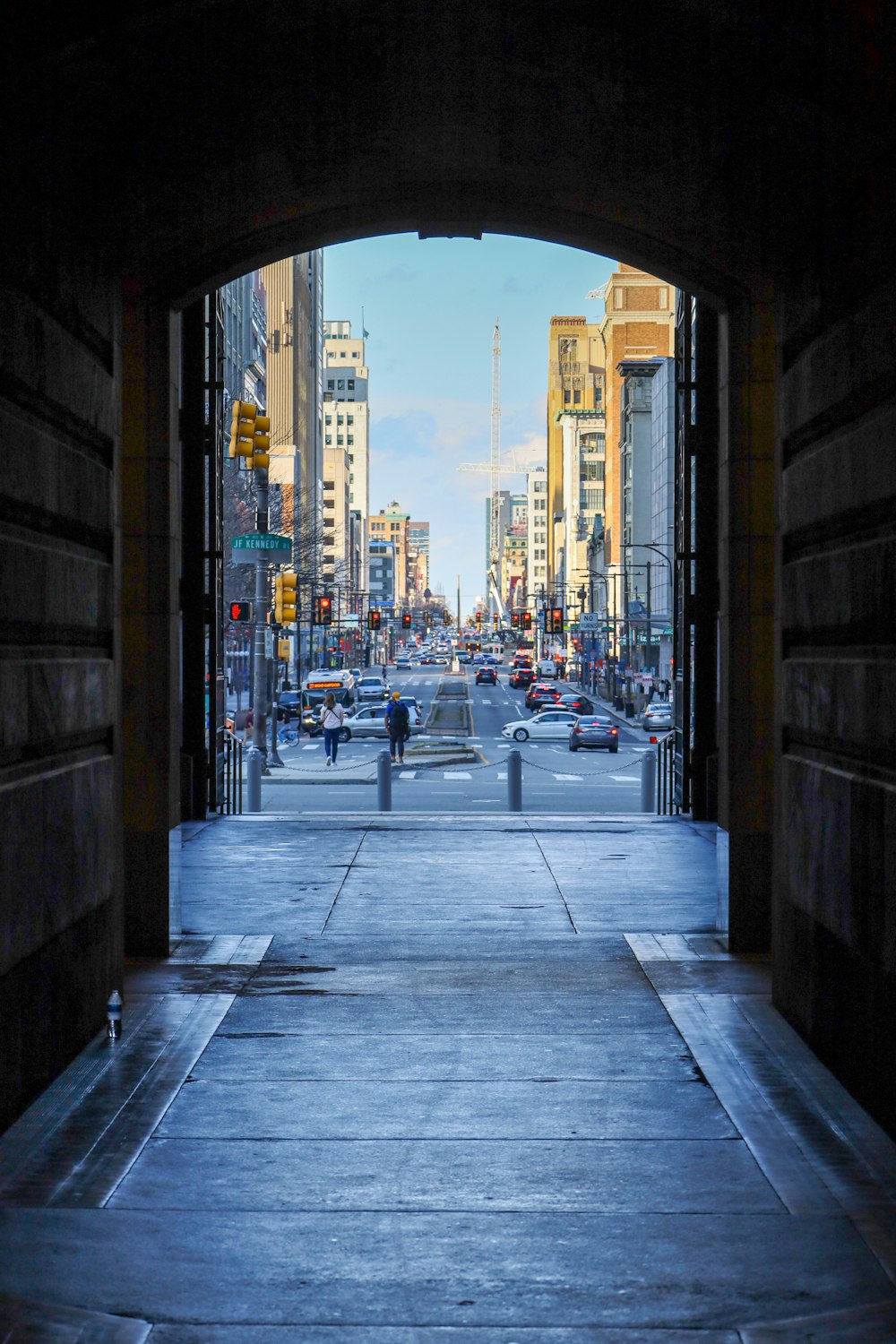 a view of a city street from a tunnel