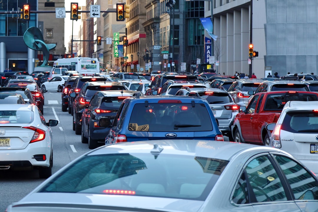 a busy city street filled with lots of traffic, City traffic in downtown Philadelphia.
