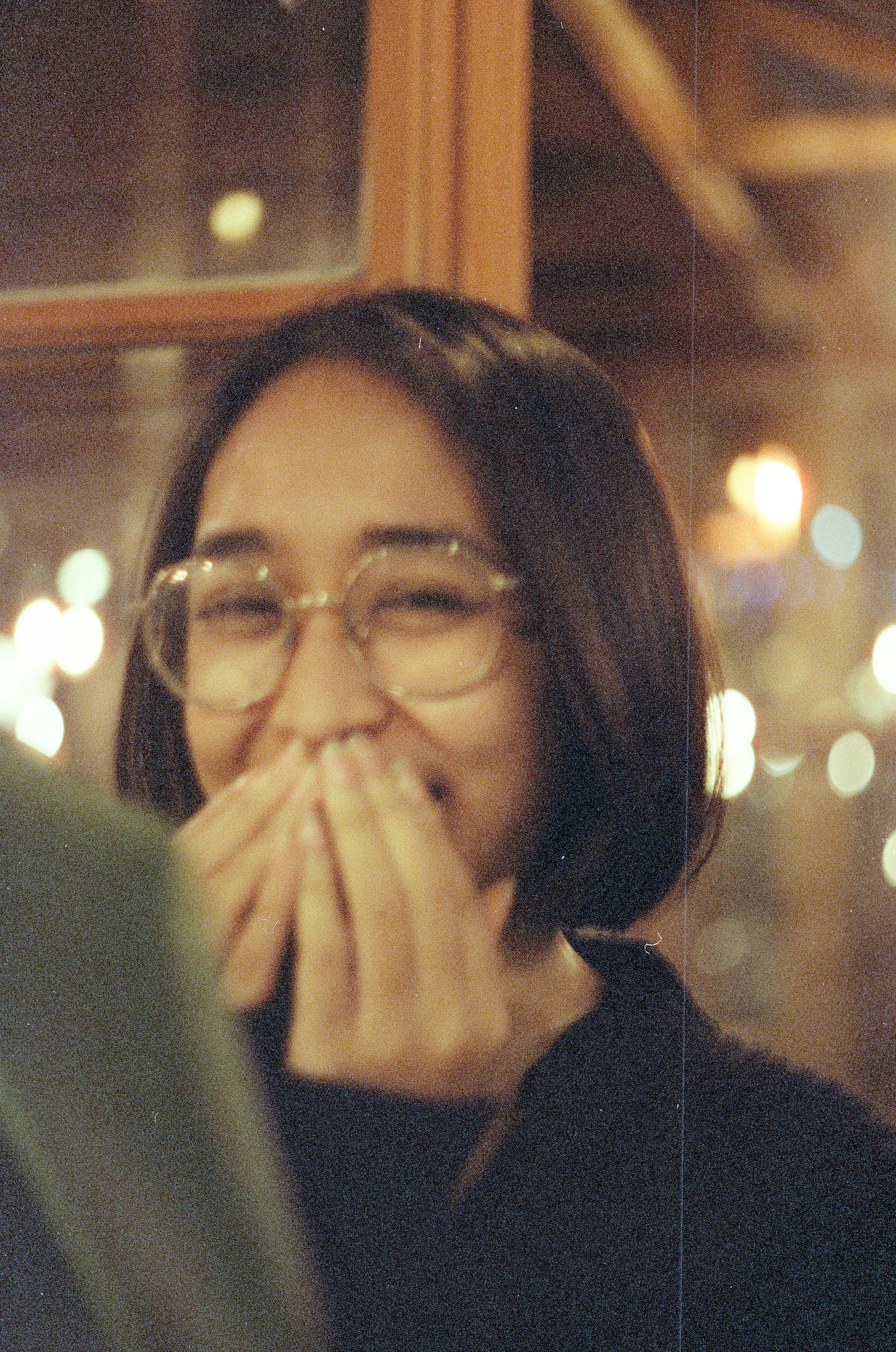 a woman wearing glasses and a black shirt