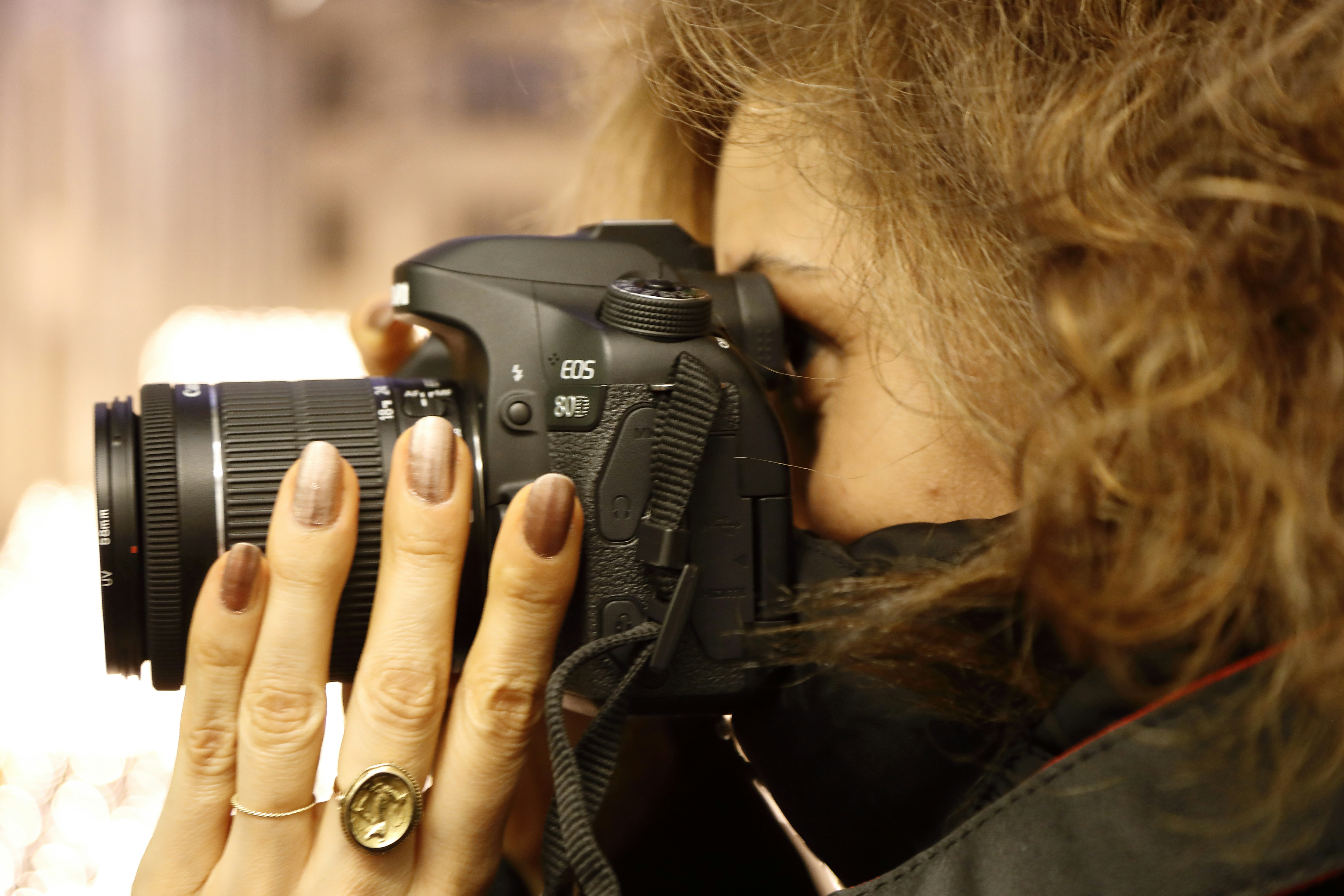 a woman holding a camera up to her face
