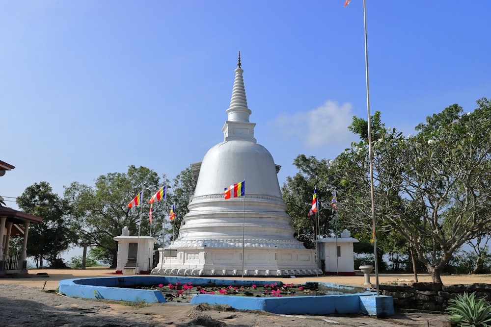 a large white building with a flag on top of it