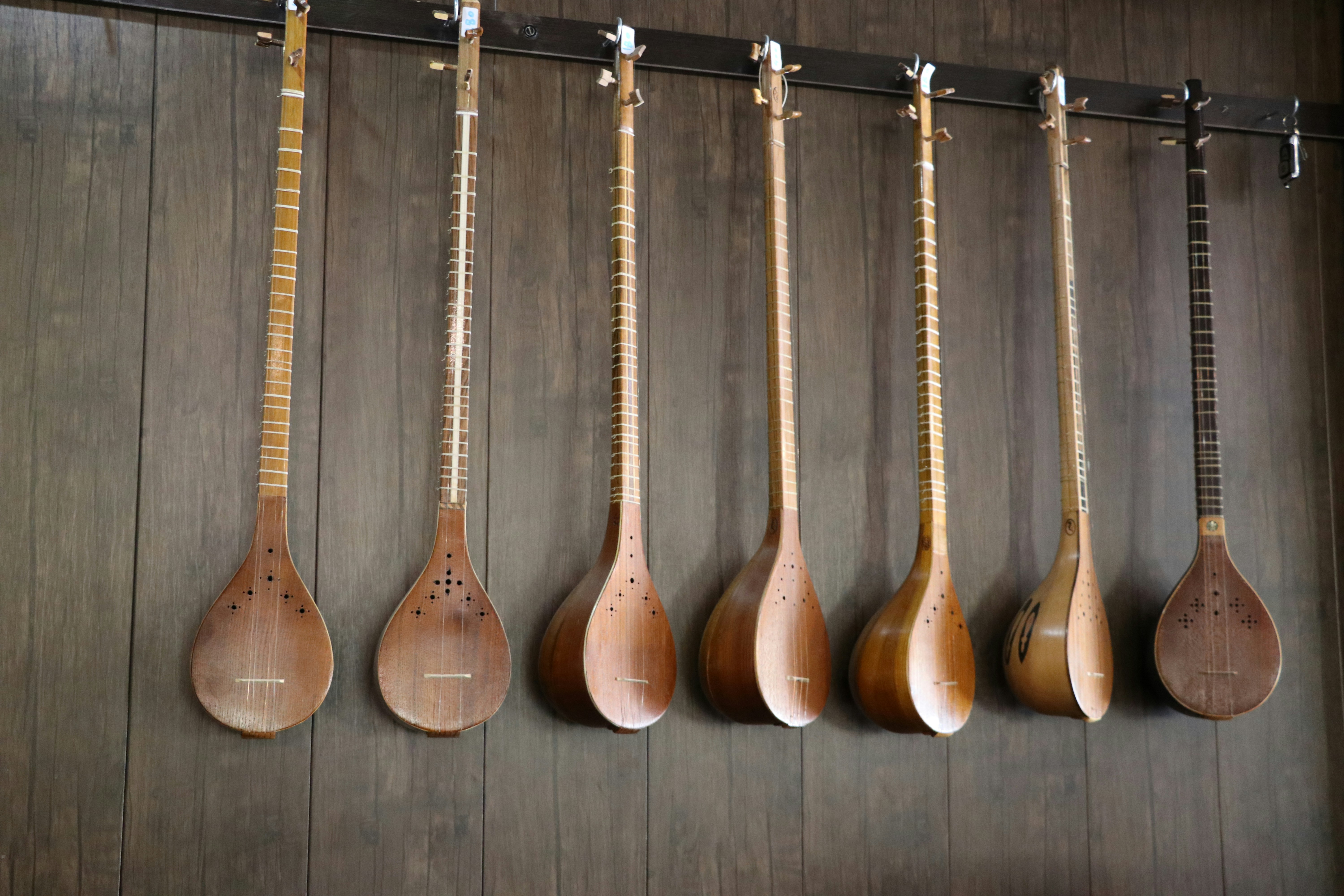 a row of wooden spoons hanging on a wall