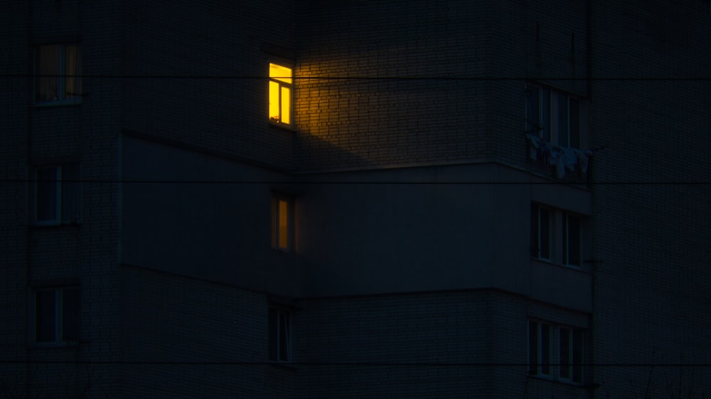 a building with a window lit up at night