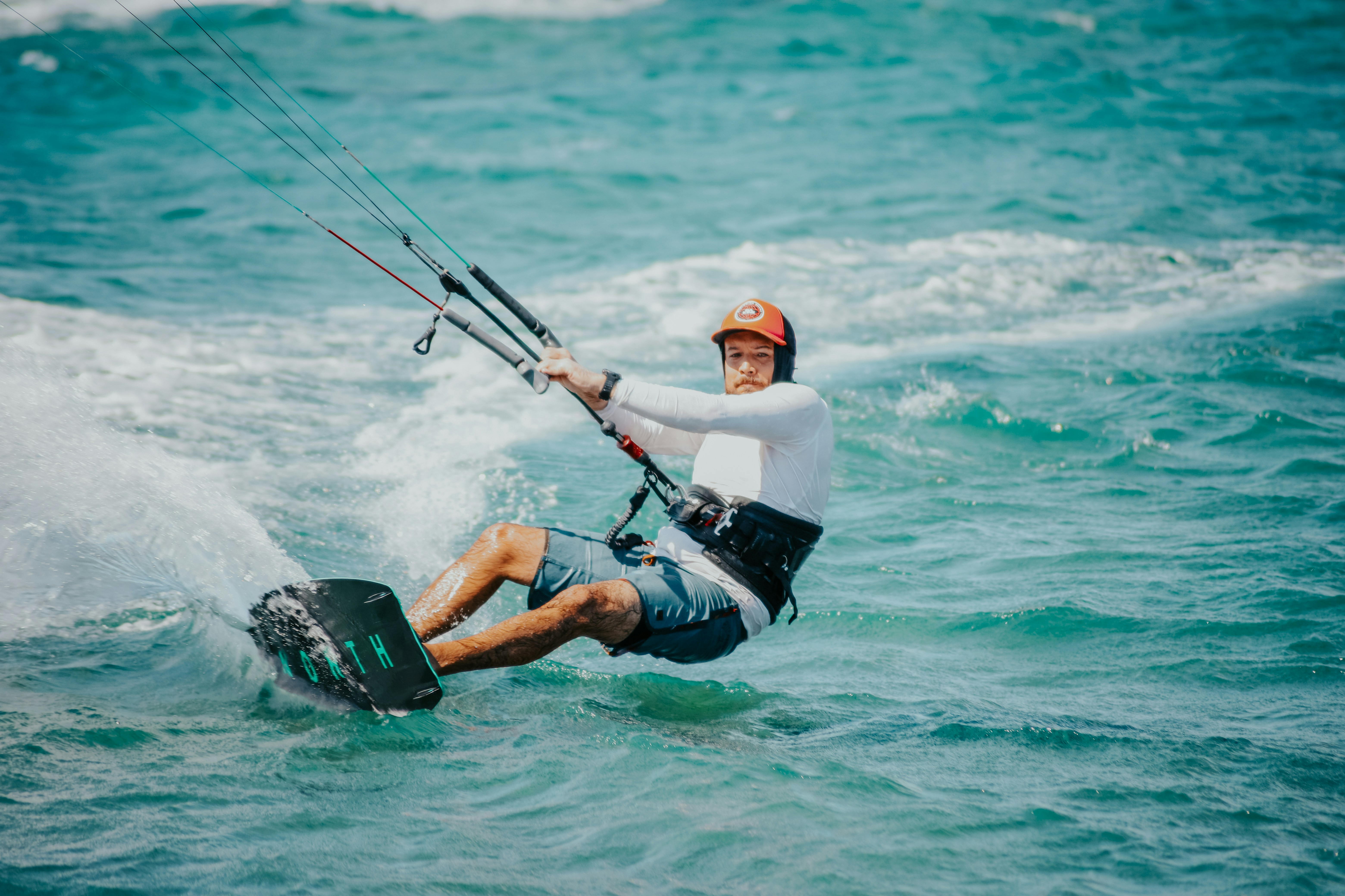 a man riding a kiteboard on top of a body of water, Kite Surfing in Punta Salinas, The Dominican Republic. It