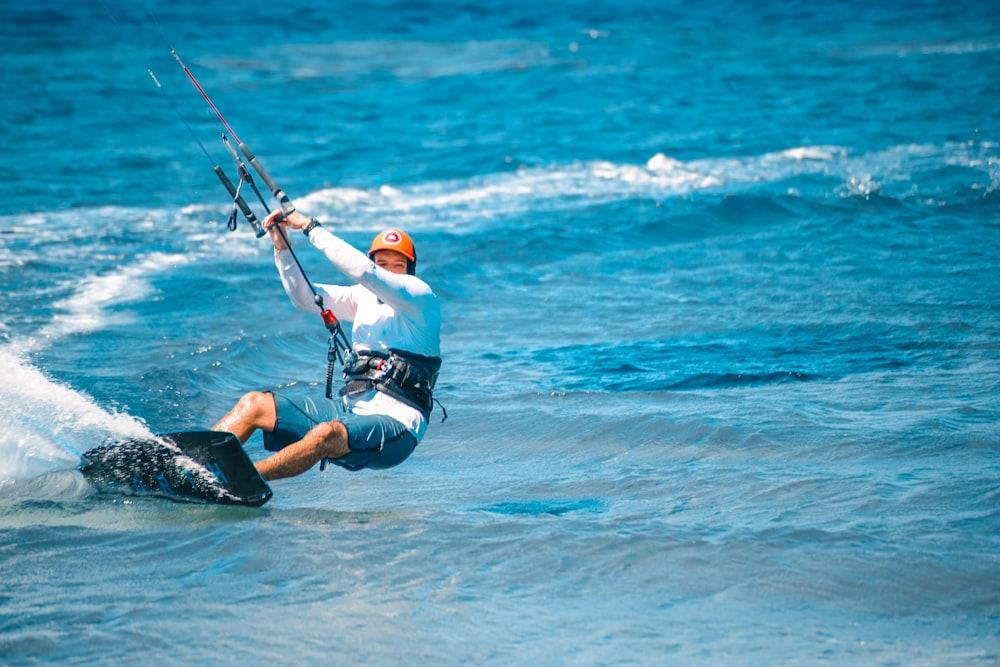 a man riding a surfboard on top of a wave in the ocean