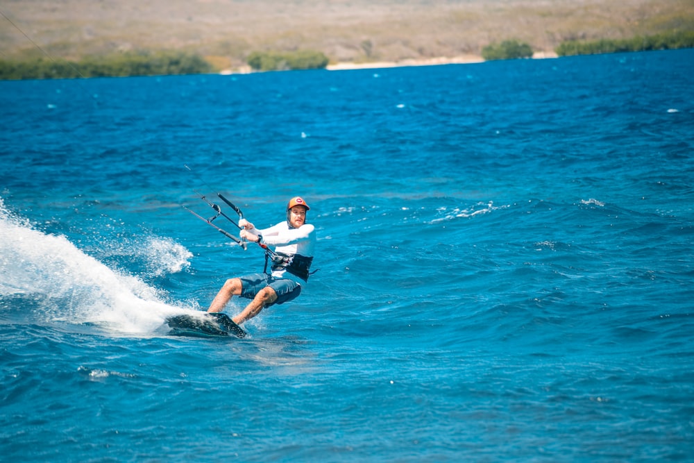 a man riding a board on top of a body of water