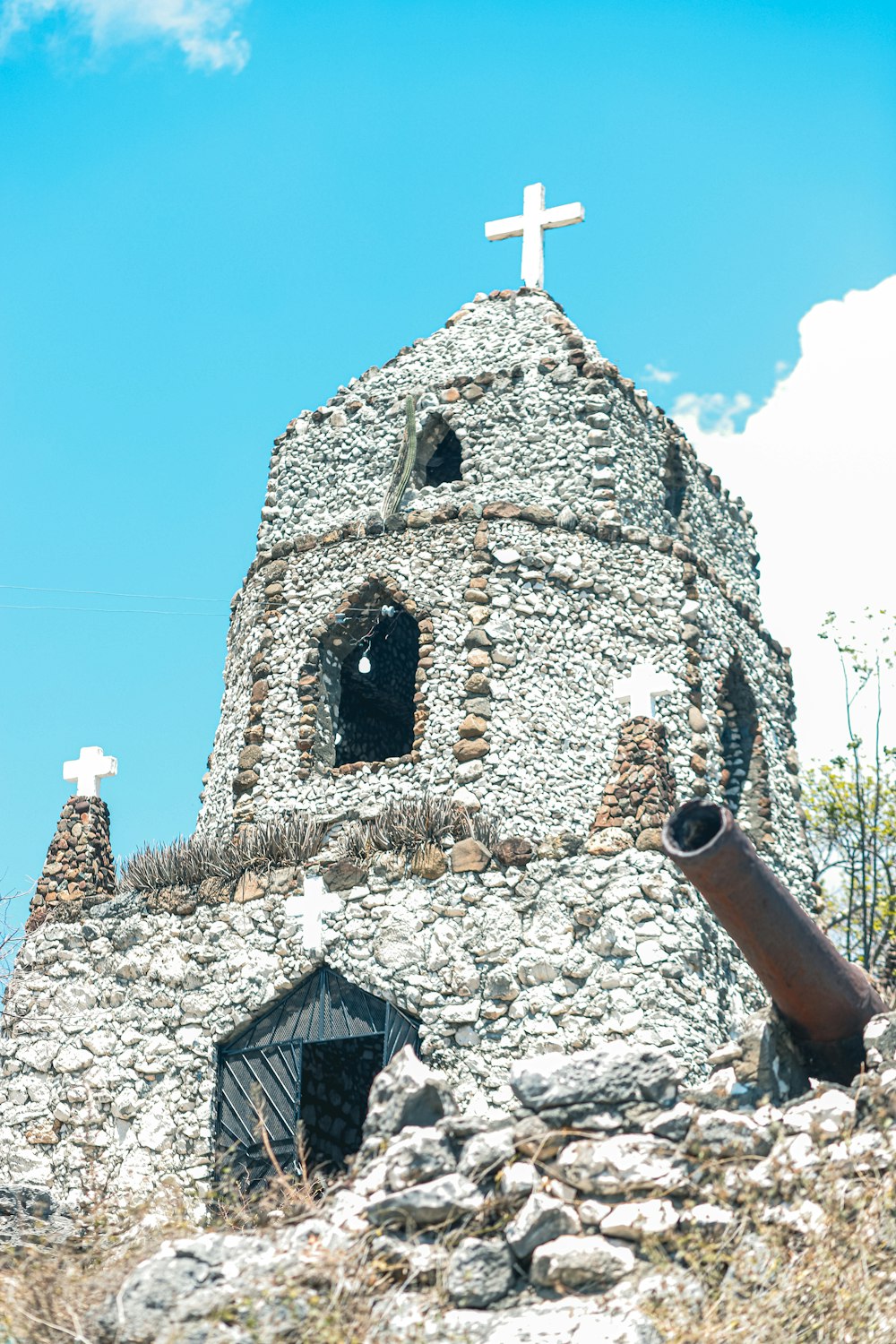 a stone building with a cross on top of it