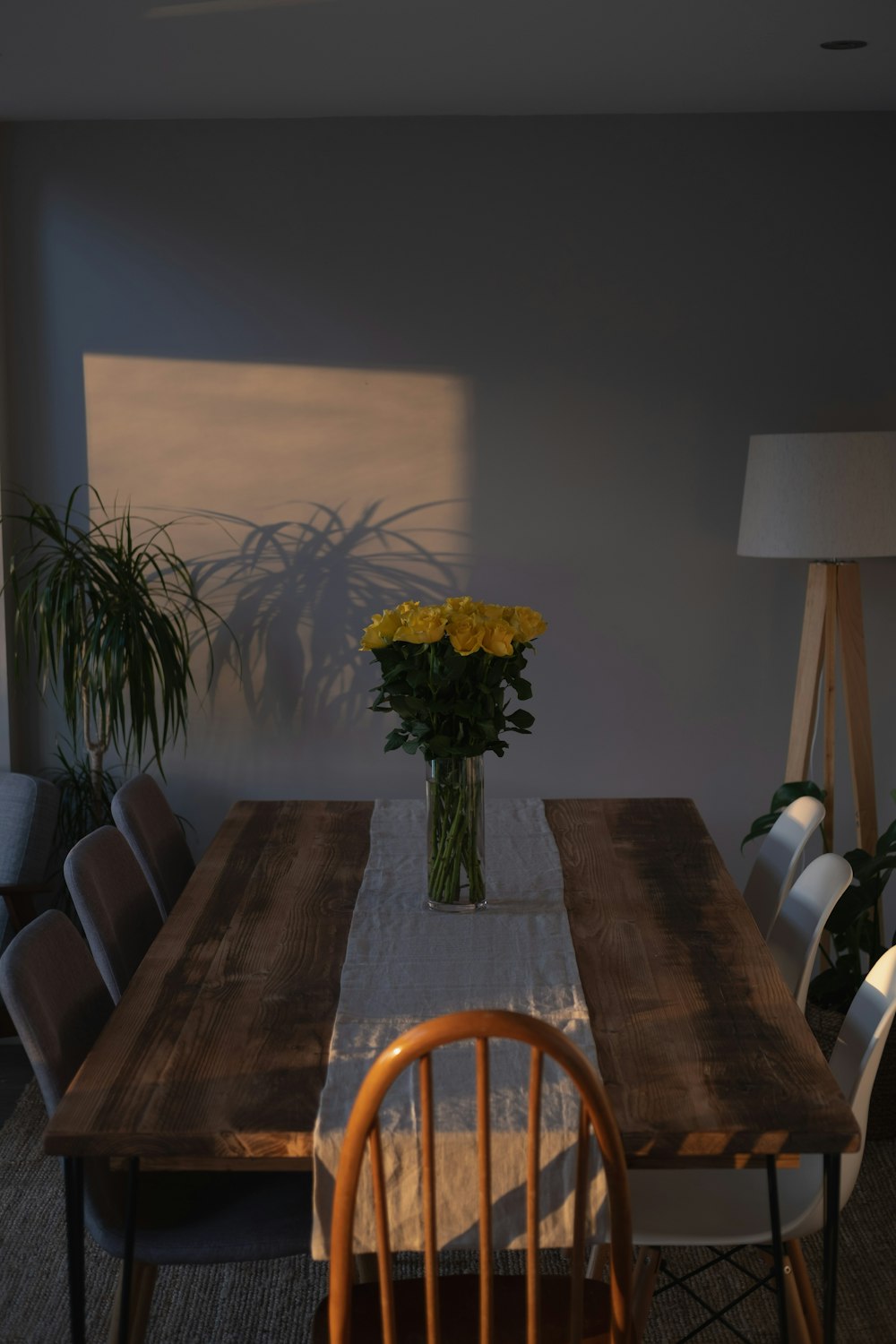 a wooden table with a vase of flowers on top of it