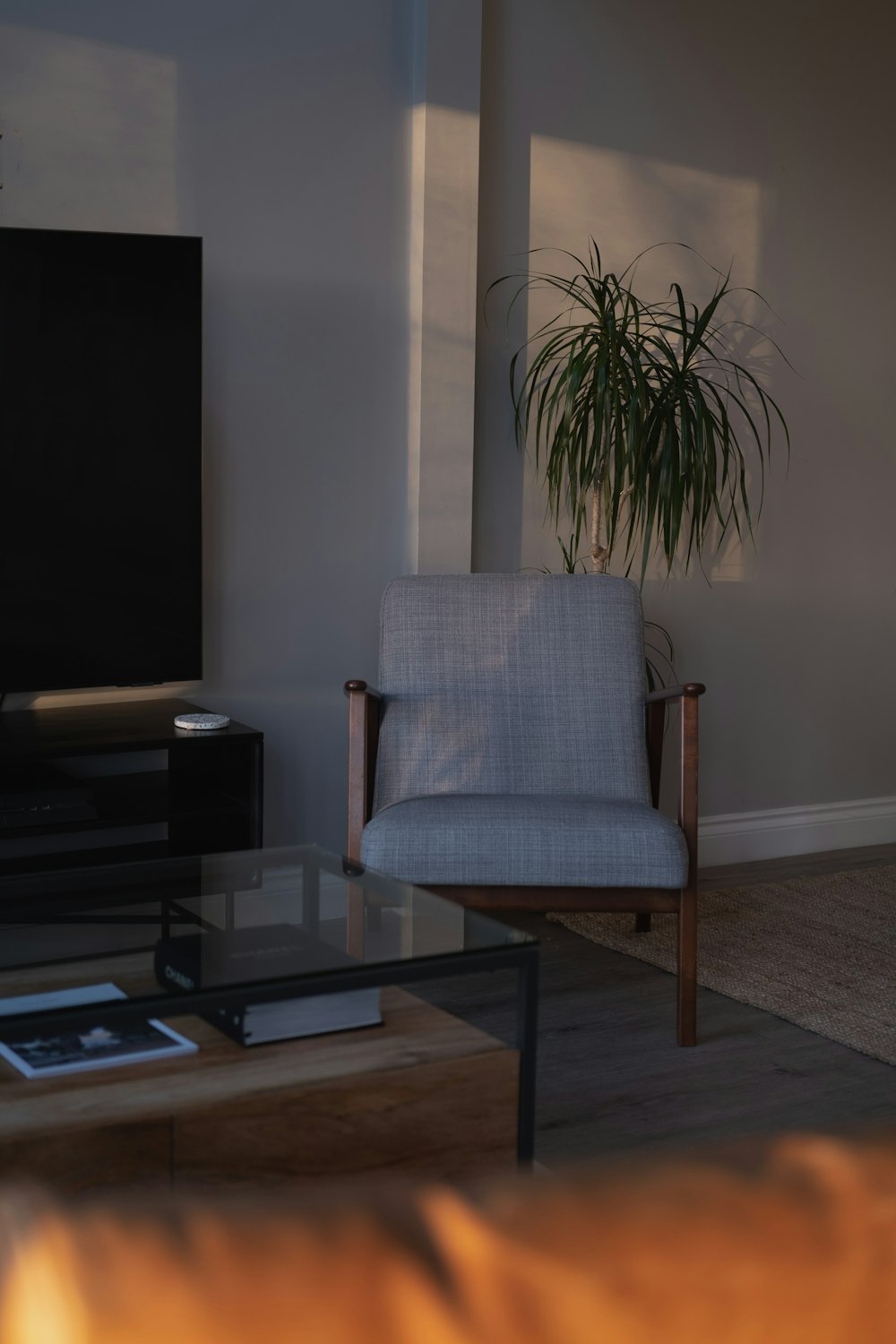 a living room with a chair and a television