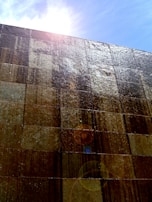 Exterior wall clad with durable, water-resistant Luxstone sheets under natural sunlight.